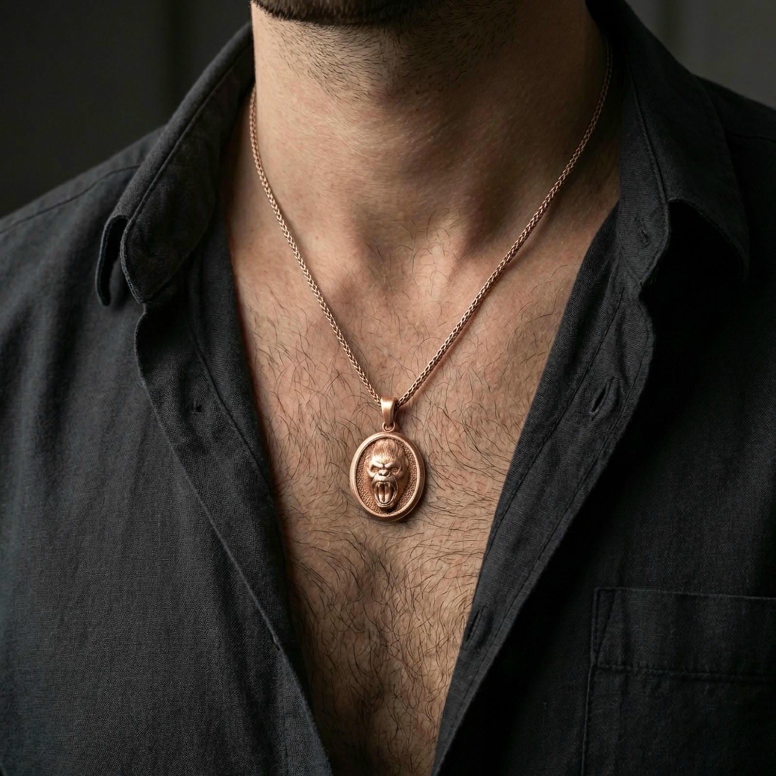Rose gold plated gorilla necklace with roaring primate motif, detailed facial sculpting, and elegant medallion silhouette worn on the neck in a refined lifestyle shot with a warm and dramatic presentation