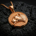 Load image into Gallery viewer, Rose gold plated lioness necklace with sculpted wild cat portrait, round medallion silhouette, and refined feminine predator design resting on volcanic rock in an elegant close-up product presentation
