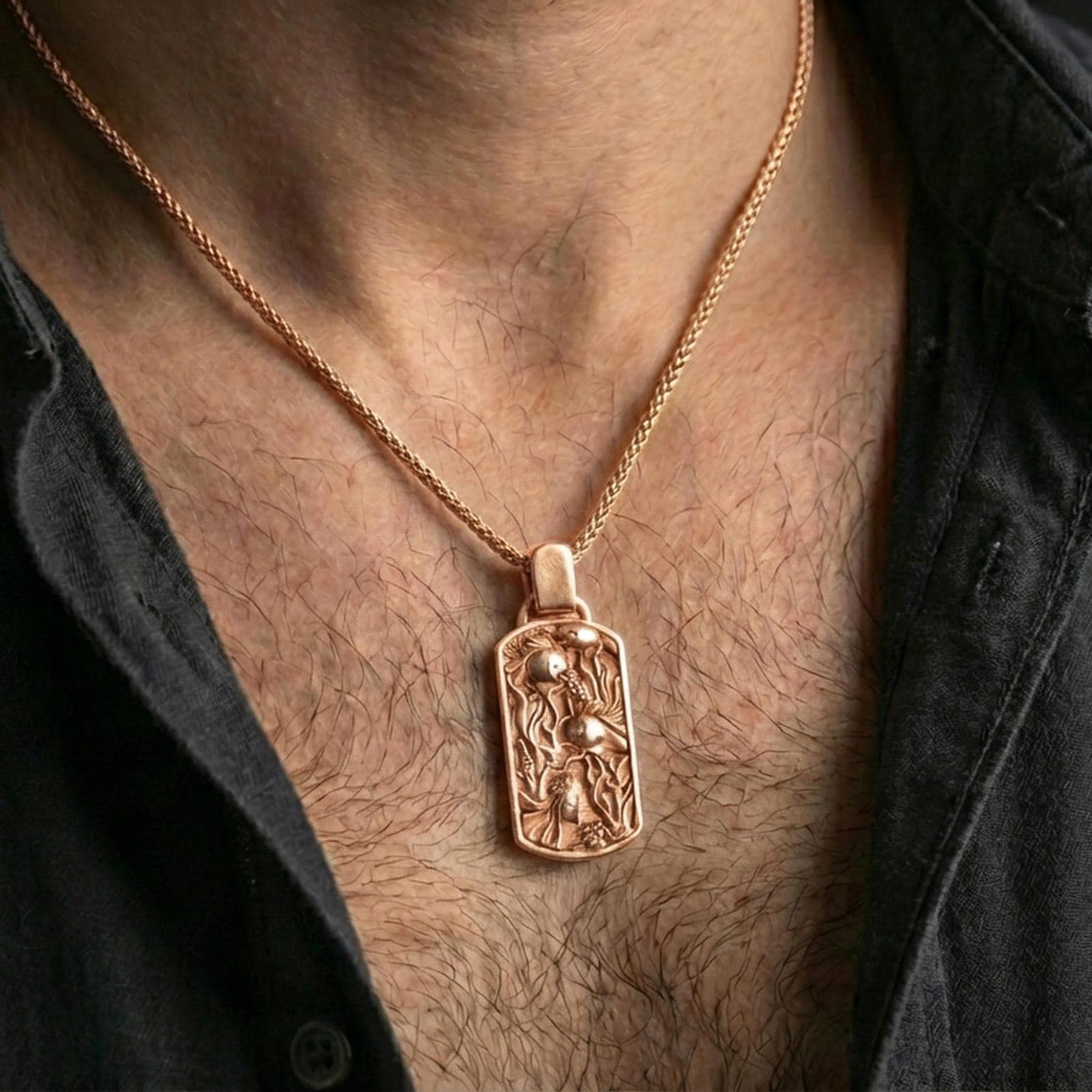 Rose gold plated fish tank necklace with detailed aquatic scene, sculpted fish relief, and refined rectangular silhouette worn on the neck in a refined lifestyle shot with a warm and sophisticated presentation