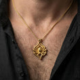 Load image into Gallery viewer, Gold plated spider pendant with bold gothic form, sculpted arachnid relief, and textured leg detailing worn on the neck in a premium lifestyle composition with strong animal-inspired jewelry styling
