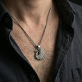 Load image into Gallery viewer, Oxidized swan pendant with sculpted feather details worn on the neck in a lifestyle jewelry shot, styled against the chest for an elegant and nature-inspired statement look
