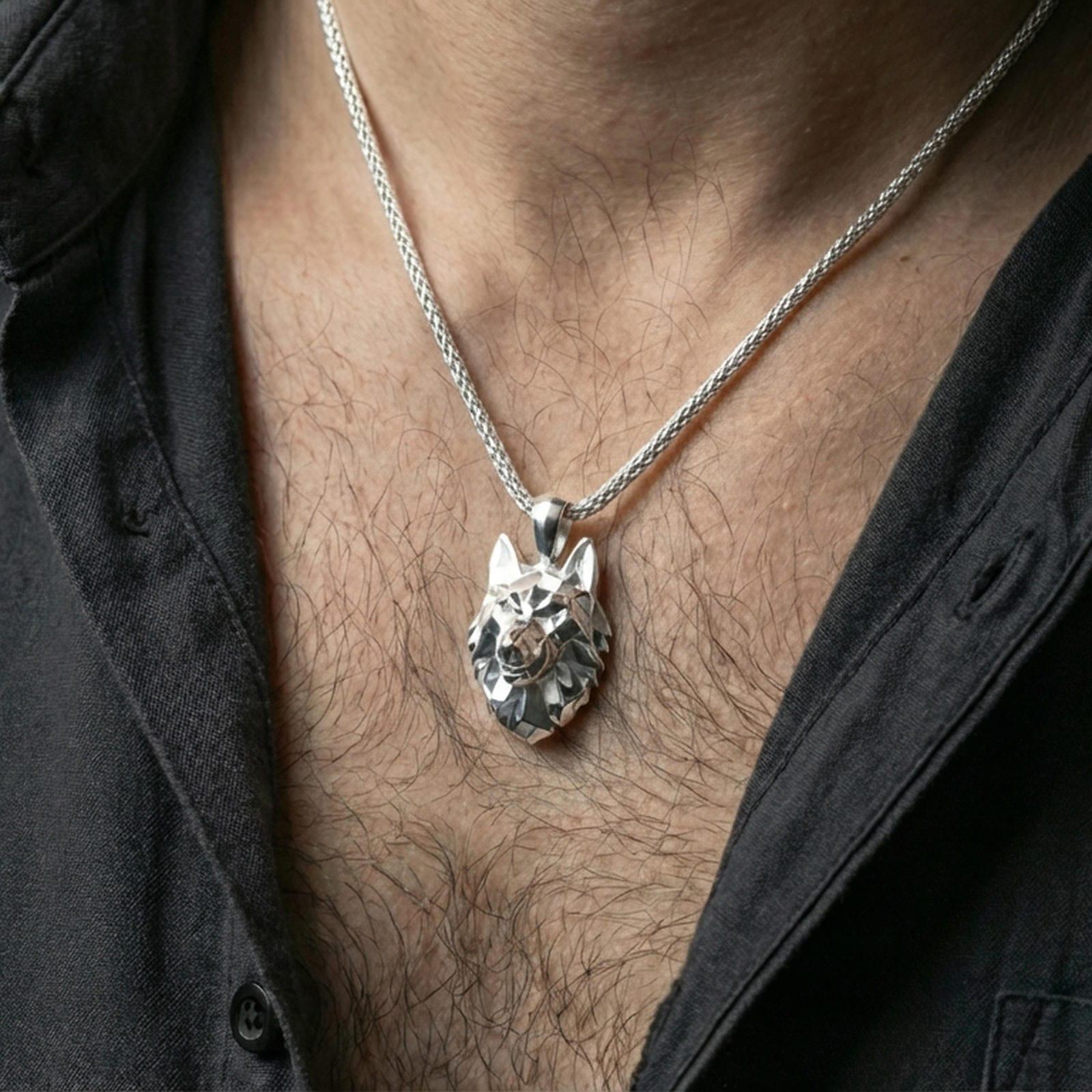 Polished silver geometric wolf necklace with angular low poly wolf head and sculpted faceted detailing worn on the neck in a close lifestyle frame, highlighting the contemporary animal silhouette and refined craftsmanship