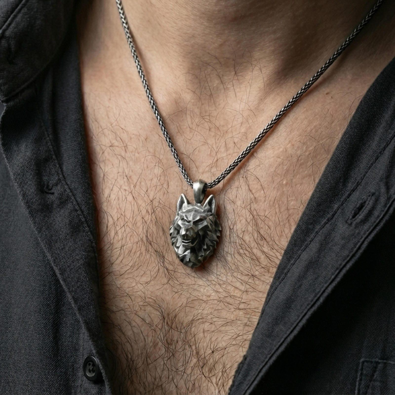 Oxidized polygonal wolf pendant with faceted spirit animal design worn on the neck in a lifestyle jewelry shot, styled against the chest for a bold and modern wilderness statement look