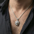 Load image into Gallery viewer, Polished silver geometric lion necklace with angular low poly lion head and sculpted faceted detailing worn on the neck in a close lifestyle frame, highlighting the contemporary animal silhouette and refined craftsmanship
