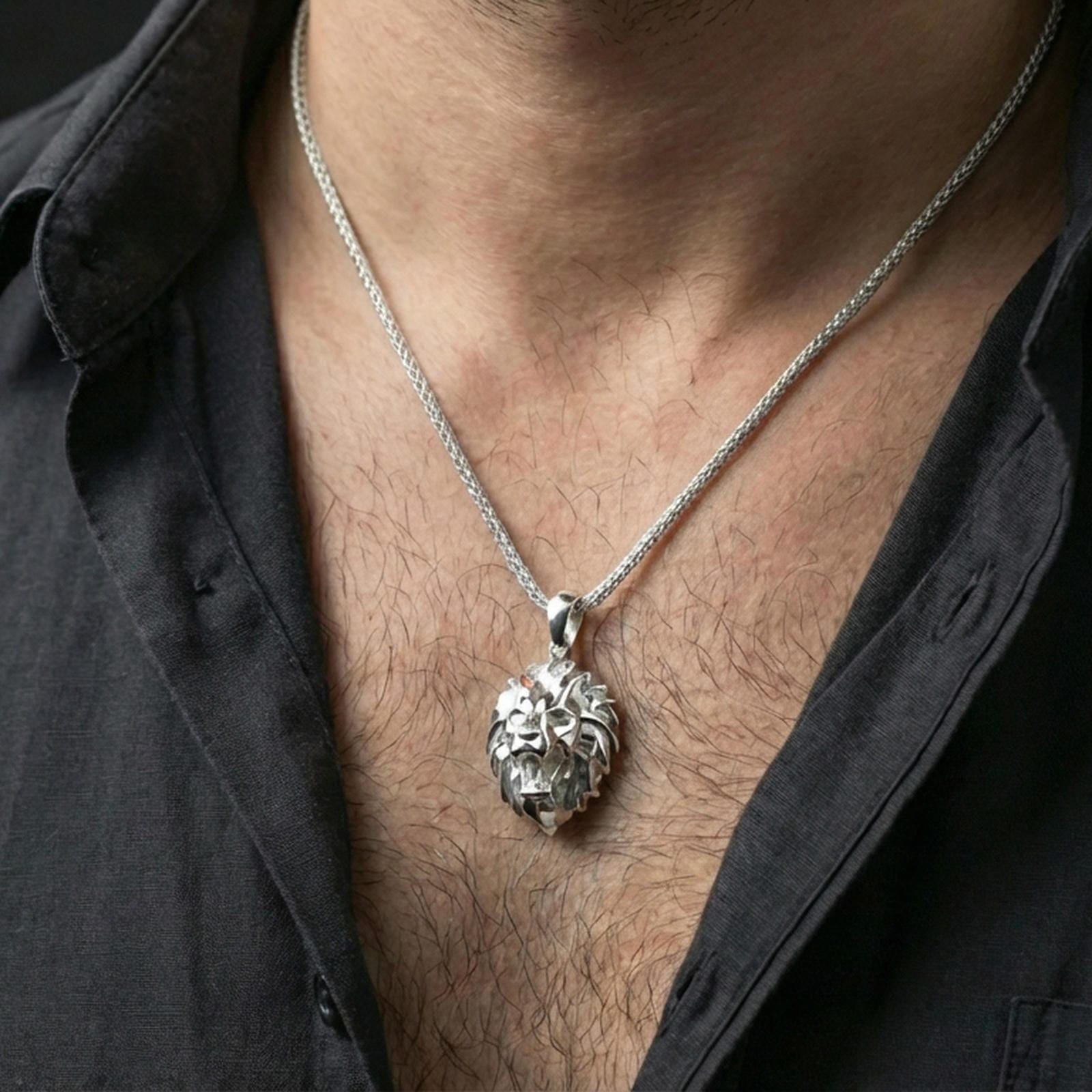 Polished silver geometric lion necklace with angular low poly lion head and sculpted faceted detailing worn on the neck in a close lifestyle frame, highlighting the contemporary animal silhouette and refined craftsmanship