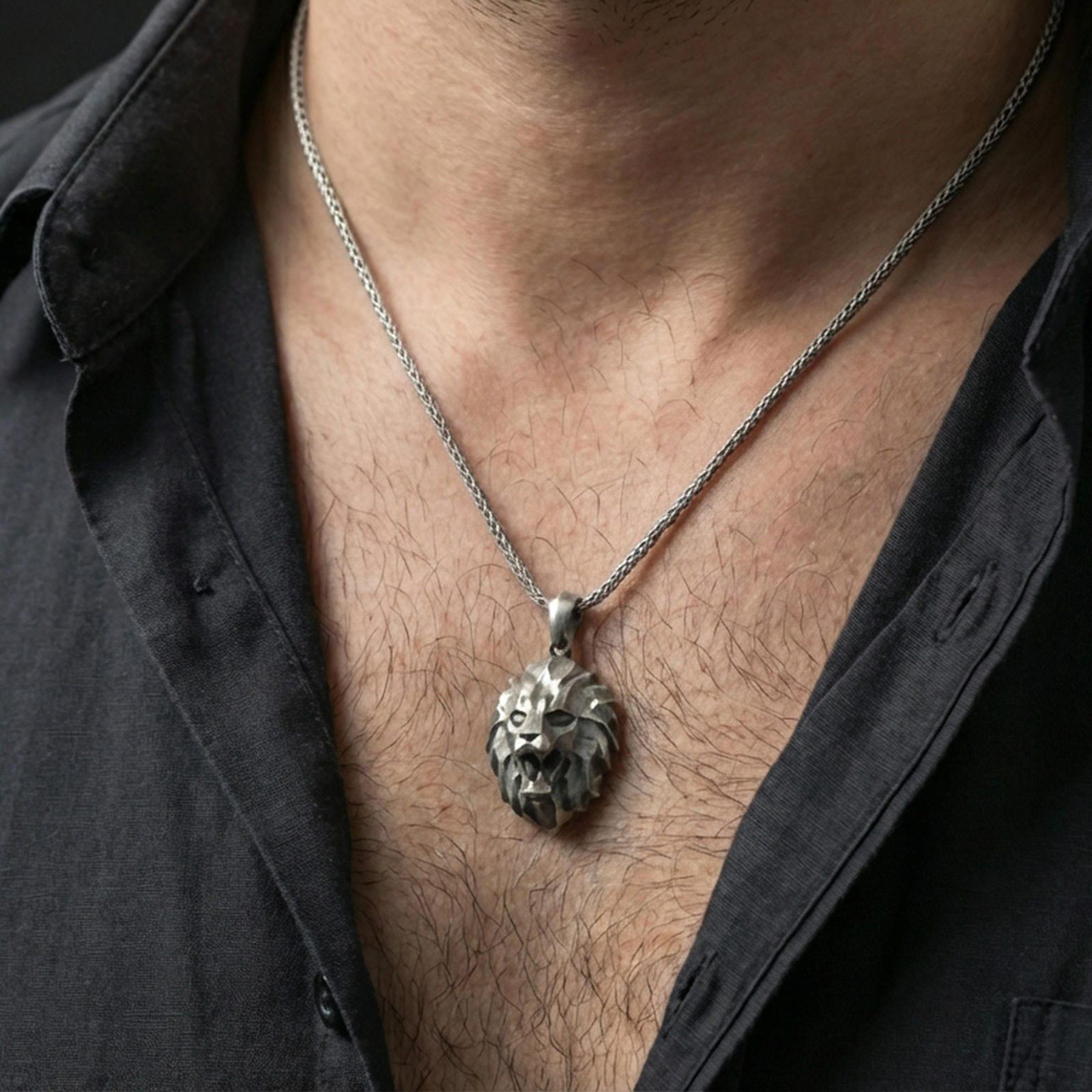 Oxidized polygonal lion pendant with faceted spirit animal design worn on the neck in a lifestyle jewelry shot, styled against the chest for a bold and modern wilderness statement look