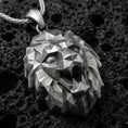 Load image into Gallery viewer, Oxidized polygonal lion pendant with faceted geometric lion head, angular sculpted planes, and bold spirit animal silhouette displayed on dark volcanic rock in a close-up luxury jewelry composition
