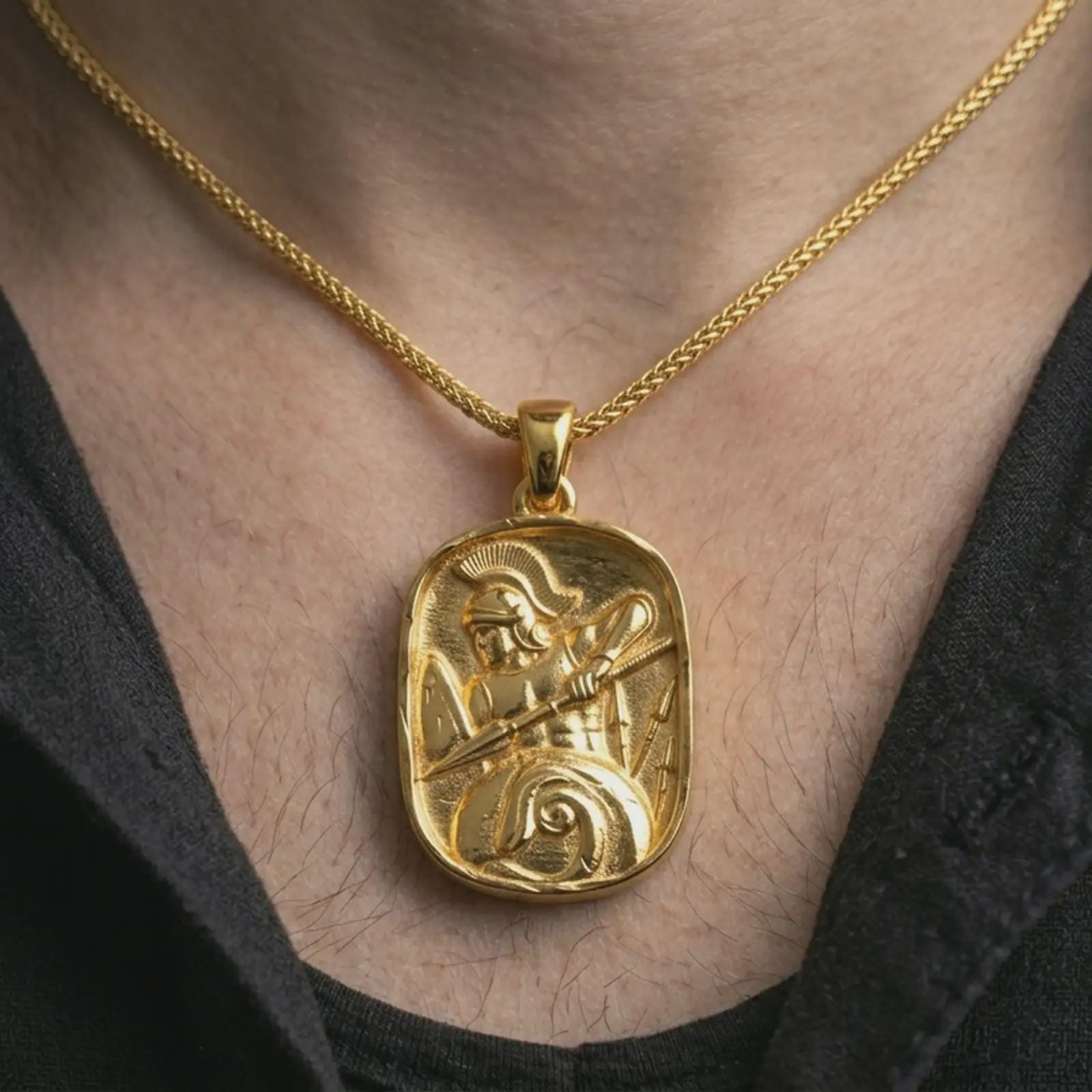 Gold plated Spartan warrior pendant necklace worn on the neck, captured on a human model in a premium dark-toned lifestyle frame.