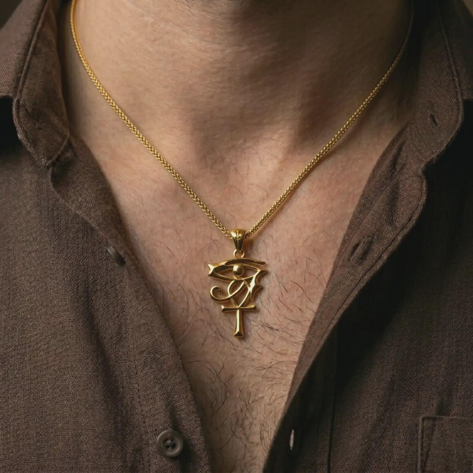 Gold plated Eye of Ra and Ankh pendant necklace worn on the neck, captured on a human model in a premium dark-toned lifestyle frame.