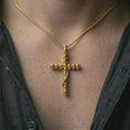 Load image into Gallery viewer, Gold plated skull cross pendant necklace worn on the neck, captured on a human model in a premium dark-toned lifestyle frame.
