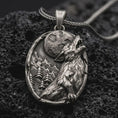 Load image into Gallery viewer, Sterling silver howling wolf pendant necklace with an oxidized finish resting on textured volcanic rock, captured in a close-up premium studio composition.
