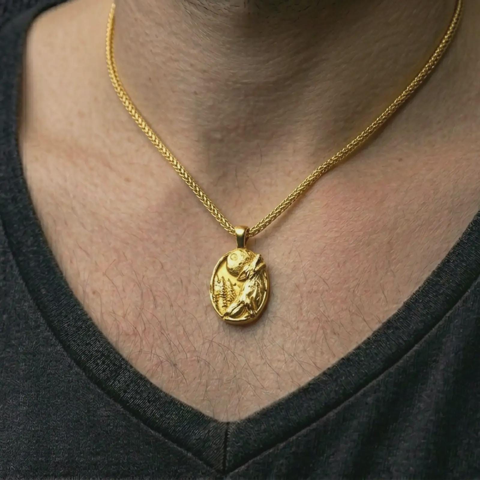 Gold plated howling wolf pendant necklace worn on the neck, captured on a human model in a premium dark-toned lifestyle frame.
