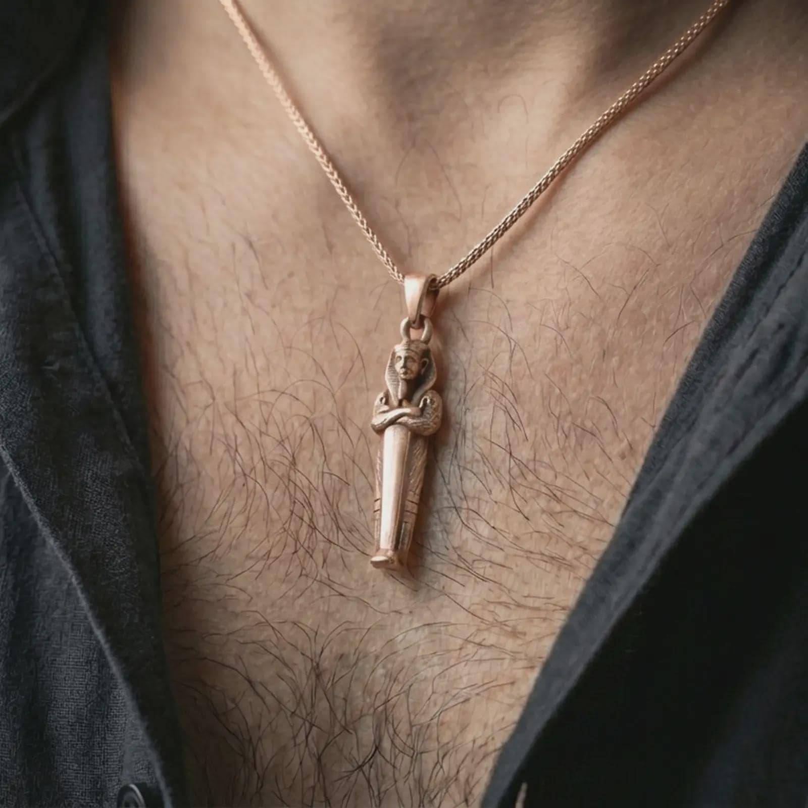 Rose gold plated King Tut pendant necklace worn on the neck, presented in a close-up lifestyle shot with a refined masculine aesthetic.
