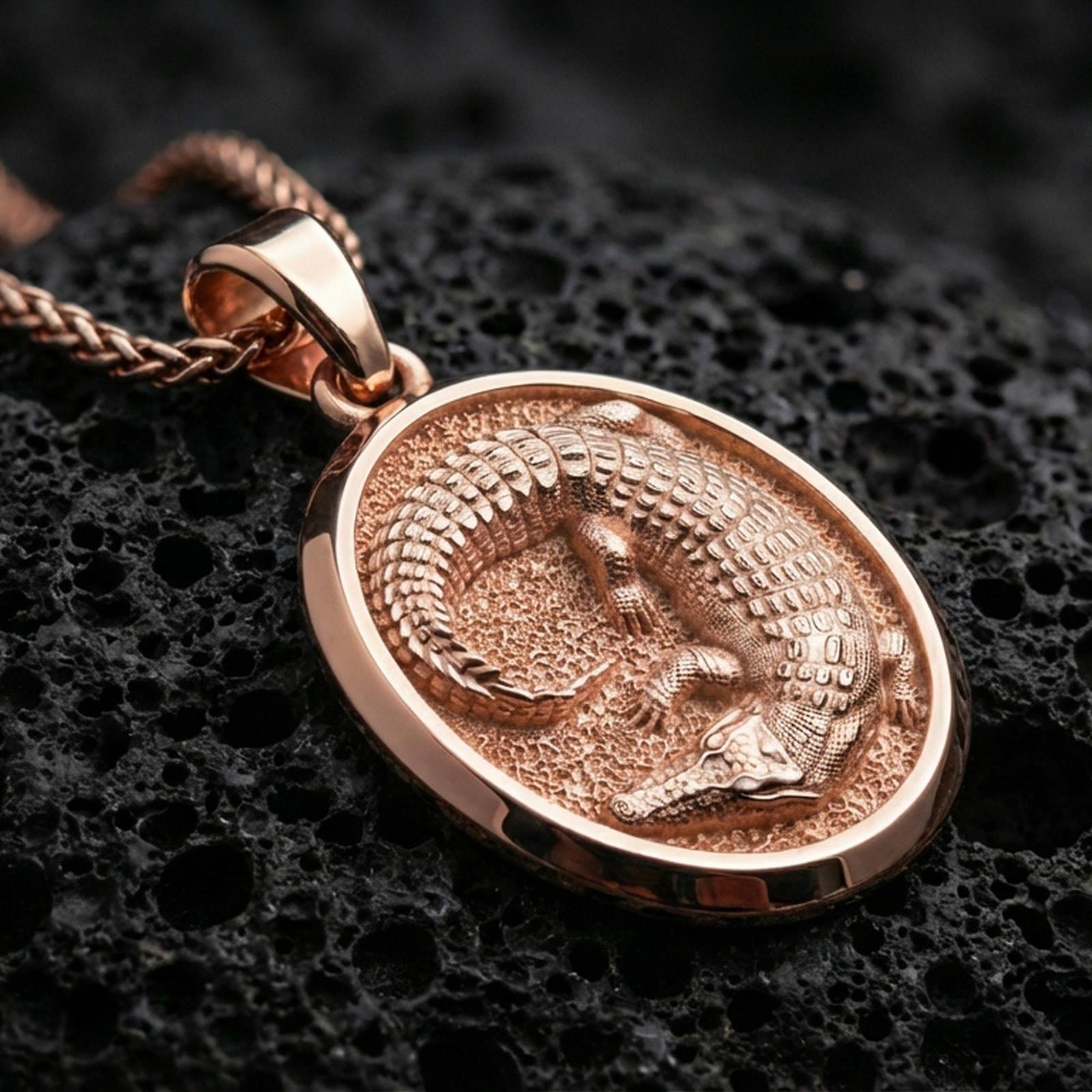 Rose gold plated crocodile pendant necklace on black volcanic rock, presented in a detailed premium studio macro view.