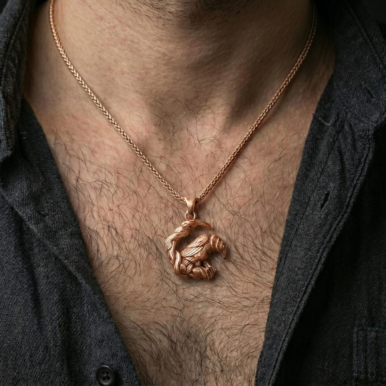 Rose gold plated Viking raven pendant necklace worn on the neck, presented in an elegant close-up styling shot with a bold masculine aesthetic.