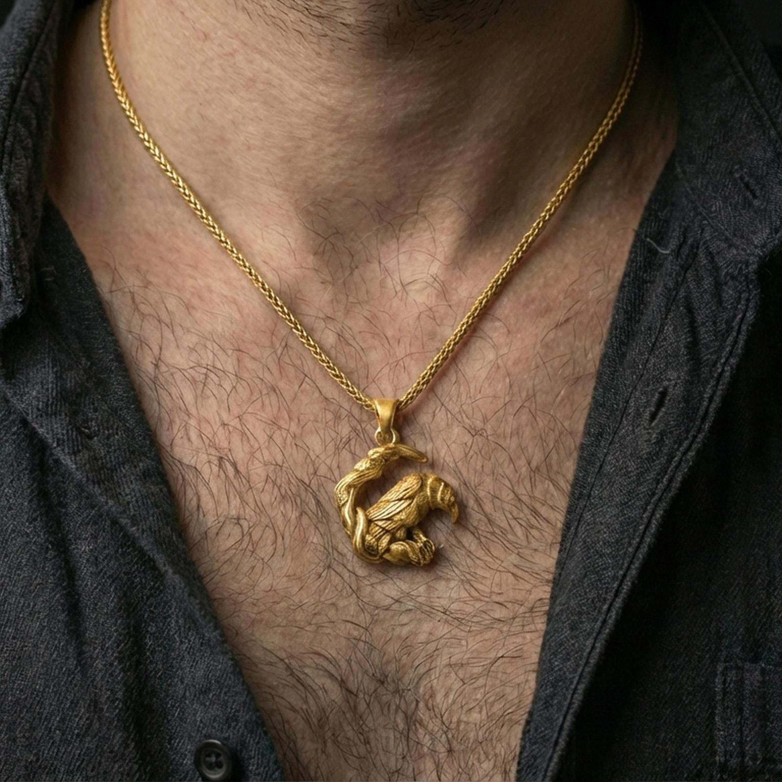 Gold plated Viking raven pendant necklace worn on the neck, captured on a human model in a premium dark-toned lifestyle frame.