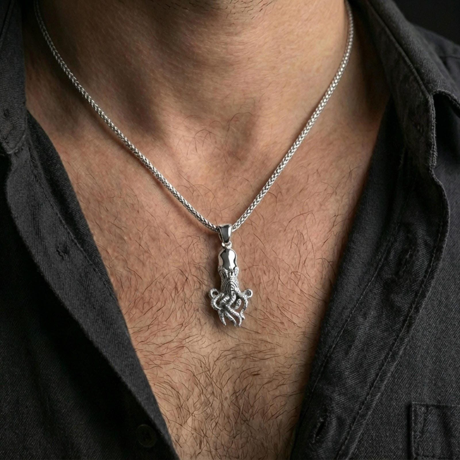 Polished silver octopus pendant necklace worn on the neck, shown against the chest in a clean and elegant everyday wear composition.