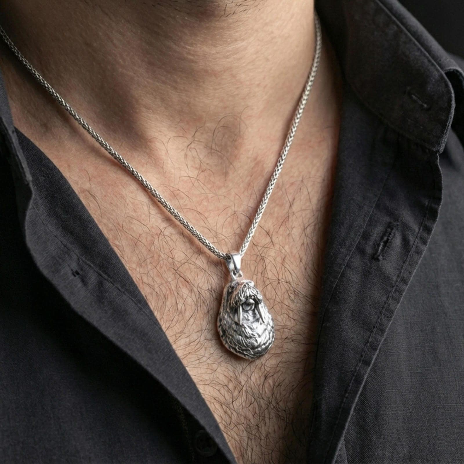 Polished silver walrus pendant necklace worn on the neck, shown against the chest in a clean and elegant everyday wear composition.