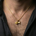 Load image into Gallery viewer, Gold plated origami elephant pendant necklace worn on the neck, captured on a human model in a premium dark-toned lifestyle frame.
