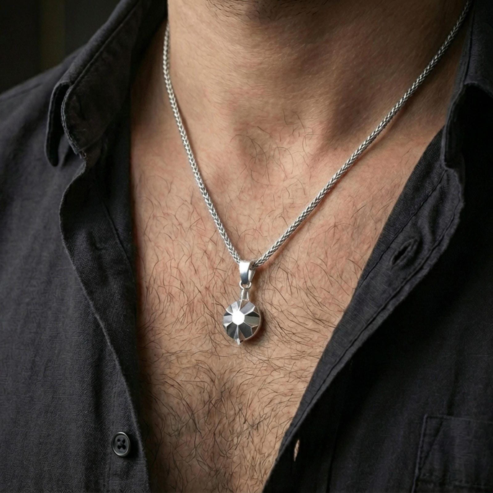 Polished silver origami tortoise pendant necklace worn on the neck, shown against the chest in a clean and elegant everyday wear composition.
