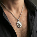 Load image into Gallery viewer, Polished silver bull pendant necklace worn on the neck, shown against the chest in a clean and elegant everyday wear composition.
