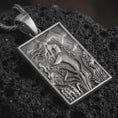 Load image into Gallery viewer, Sterling silver mermaid pendant necklace with an oxidized finish resting on textured volcanic rock, captured in a close-up premium studio composition.
