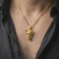 Load image into Gallery viewer, Gold plated Oni mask pendant necklace worn on the neck, captured on a human model in a premium dark-toned lifestyle frame.
