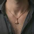 Load image into Gallery viewer, Rose gold plated origami airplane pendant necklace worn on the neck, presented in a close-up lifestyle shot with a refined masculine aesthetic.
