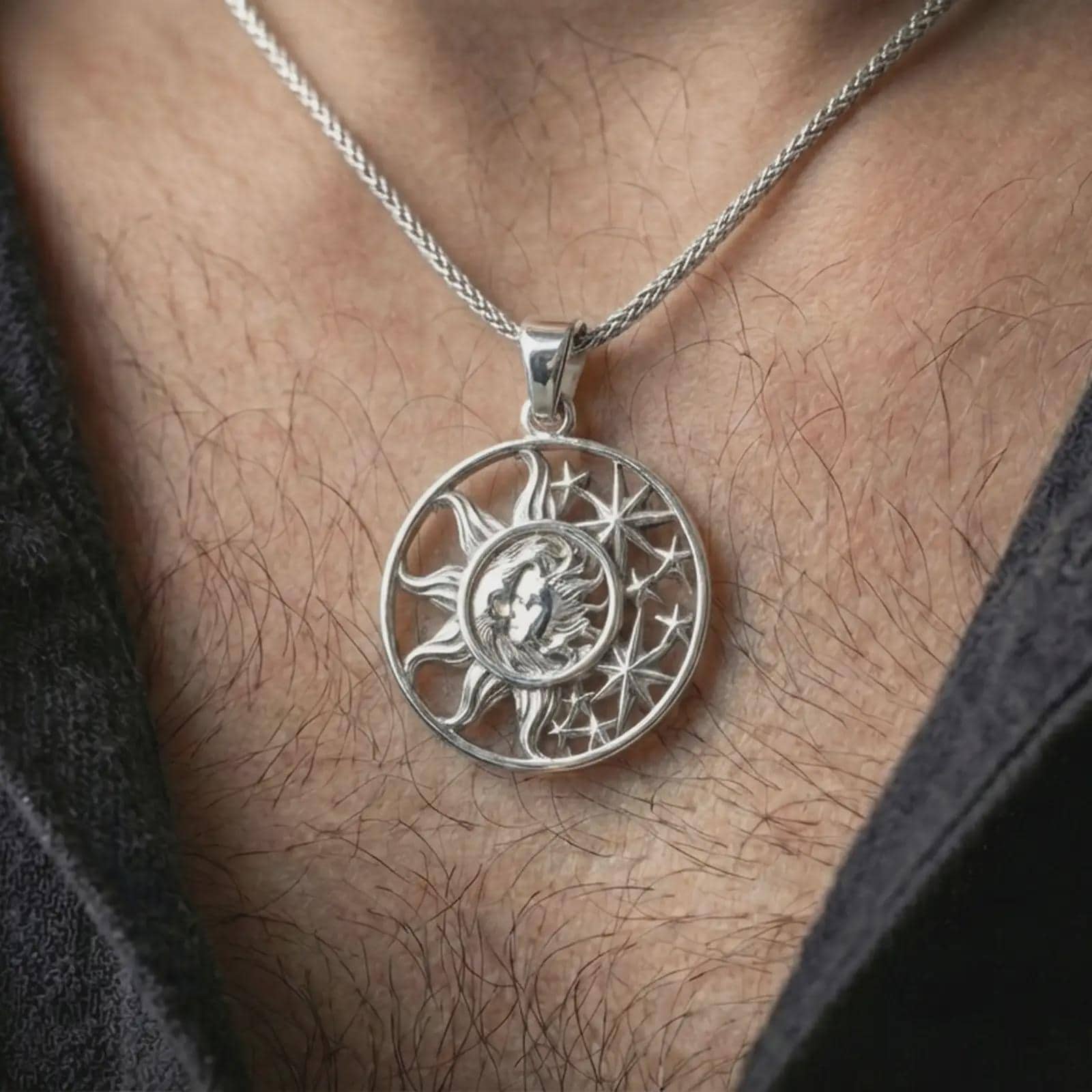Polished silver sun and moon pendant necklace worn on the neck, shown against the chest in a clean and elegant everyday wear composition.