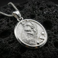 Load image into Gallery viewer, Polished silver squirrel pendant necklace displayed on black volcanic rock, shown in a refined macro product shot with detailed fur and acorn relief.
