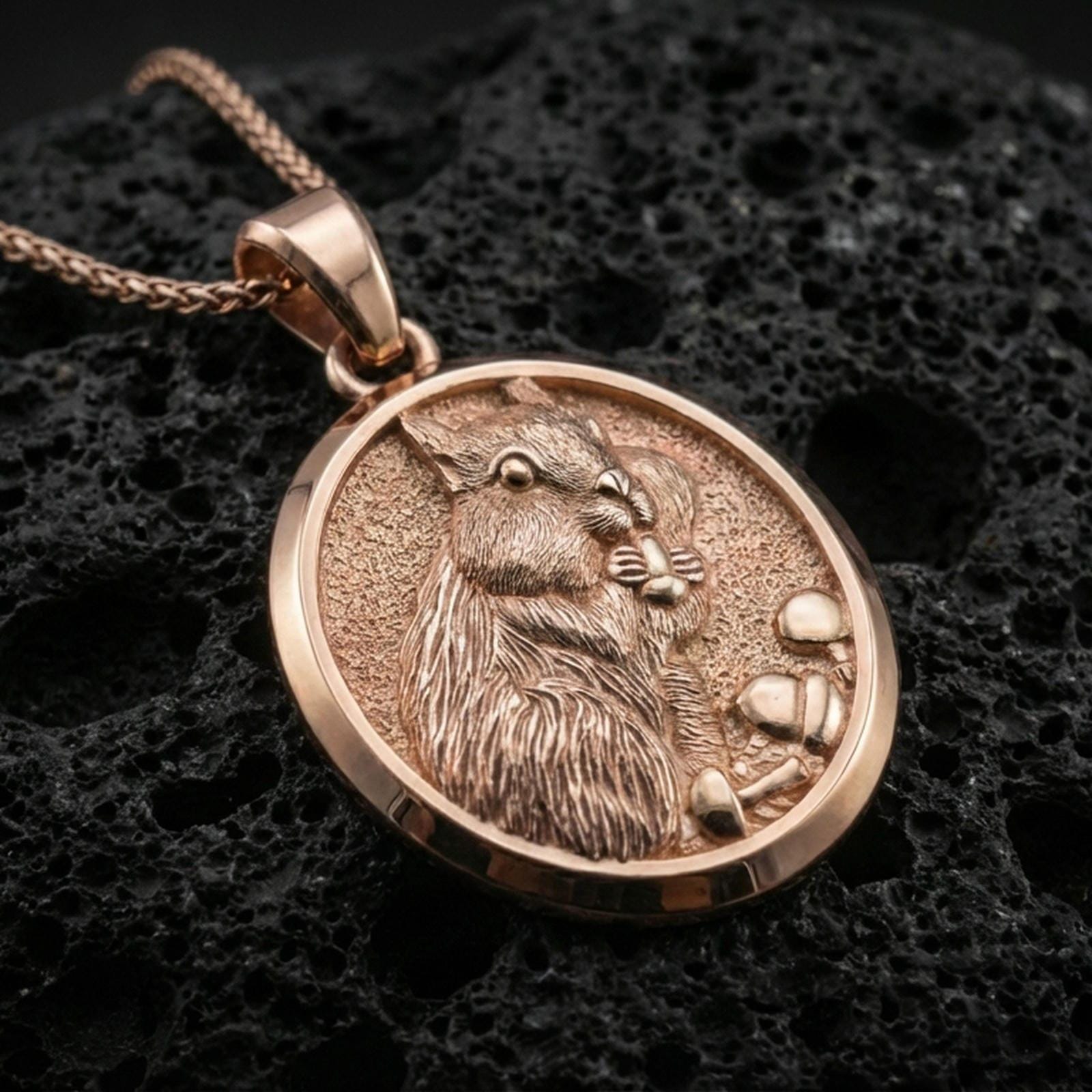 Rose gold plated squirrel pendant necklace on dark volcanic rock, photographed in a detailed premium studio macro view.