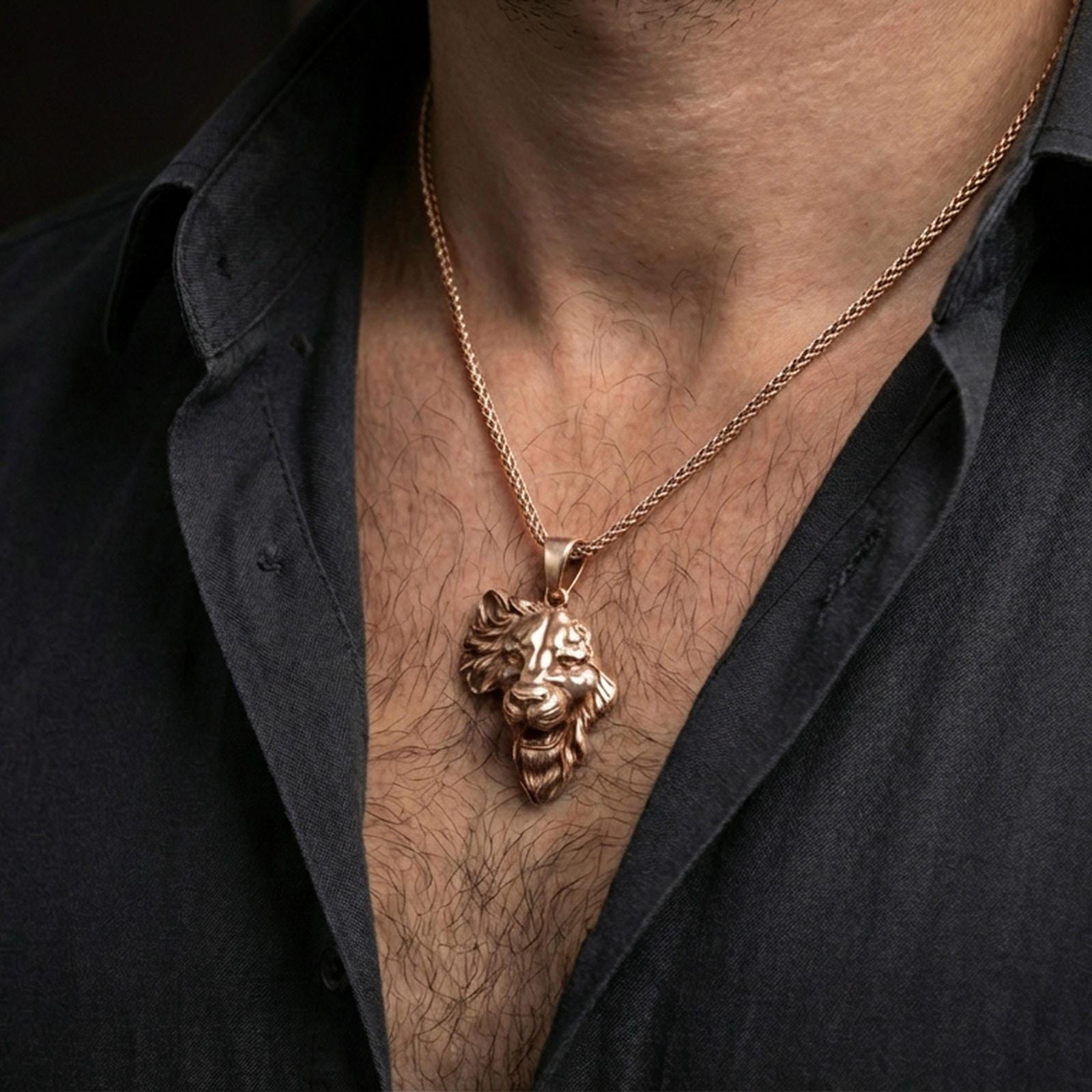 Rose gold plated lion head pendant necklace worn on the neck, presented in a close-up lifestyle shot with a refined masculine aesthetic.