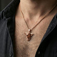 Load image into Gallery viewer, Rose gold plated buffalo head pendant necklace worn on the neck, presented in a close-up lifestyle shot with a refined masculine aesthetic.
