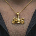 Load image into Gallery viewer, Gold plated sportbike motorcycle pendant necklace worn on the neck, captured on a human model in a premium dark-toned lifestyle frame.
