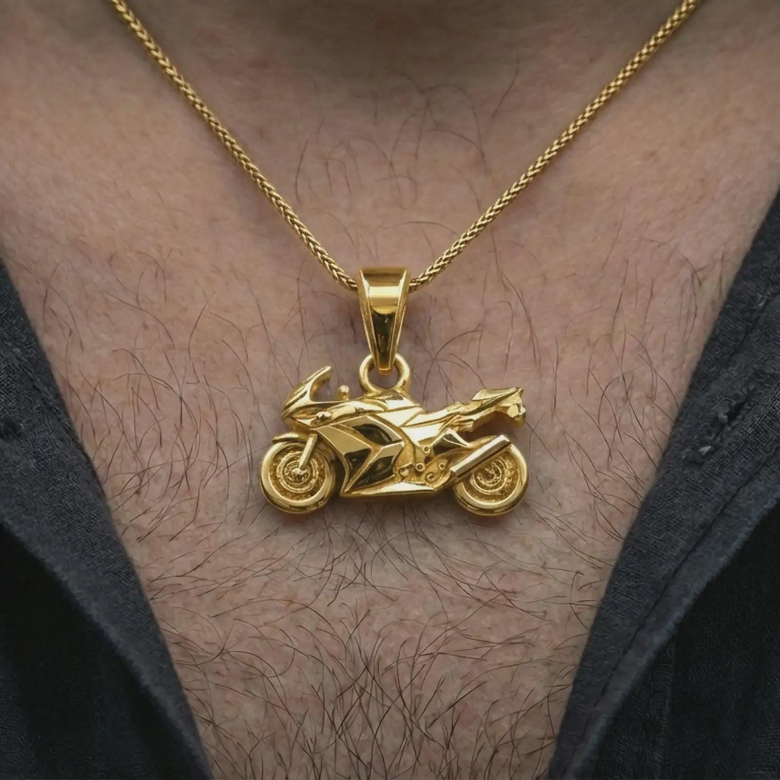 Gold plated sportbike motorcycle pendant necklace worn on the neck, captured on a human model in a premium dark-toned lifestyle frame.
