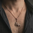 Load image into Gallery viewer, Rose gold plated paladin hammer pendant necklace worn on the neck, presented in a close-up lifestyle shot with a refined masculine aesthetic.
