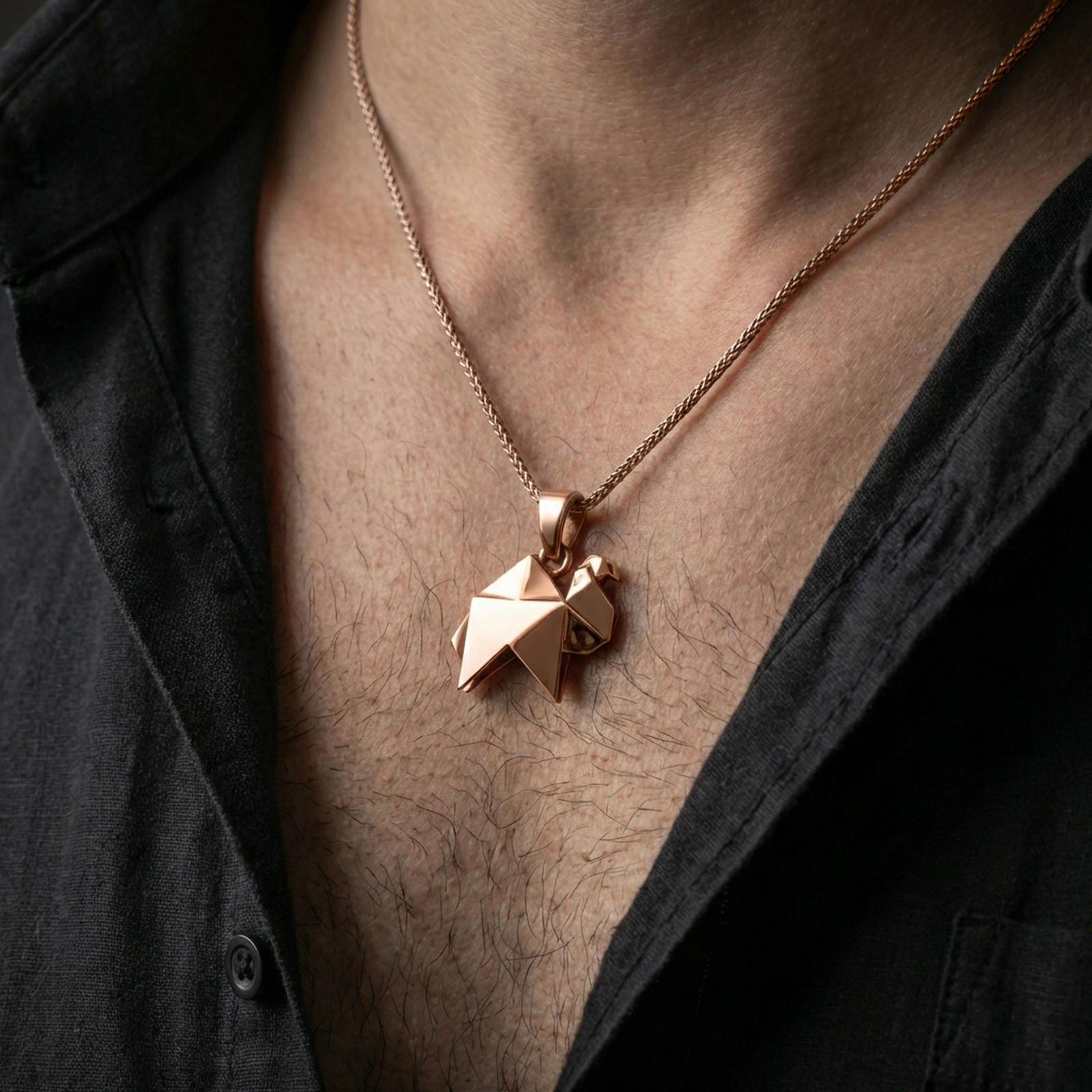 Rose gold plated origami camel pendant necklace worn on the neck, presented in a close-up lifestyle shot with a refined masculine aesthetic.
