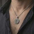 Load image into Gallery viewer, Oxidized Art Nouveau woman pendant necklace worn on the neck, styled in a dark lifestyle portrait with an open shirt and elegant presentation.
