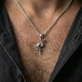 Load image into Gallery viewer, Polished silver origami flamingo pendant necklace worn on the neck, shown against the chest in a clean and elegant everyday wear composition.
