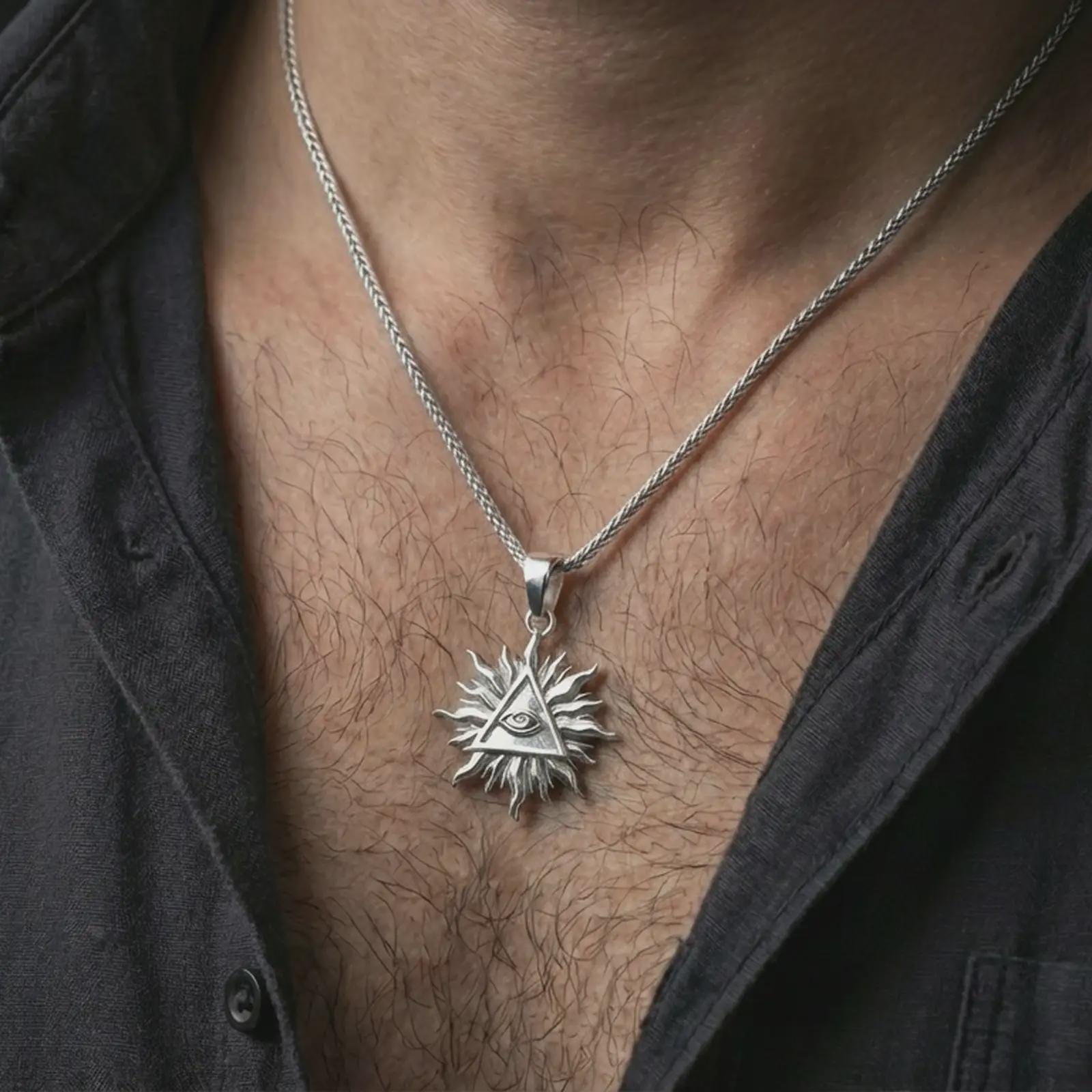 Polished silver Eye of Providence sun pendant necklace worn on the neck, shown against the chest in a clean and elegant everyday wear composition.