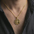 Load image into Gallery viewer, Gold plated Venus Amor pendant necklace worn on the neck, captured on a human model in a premium dark-toned lifestyle frame.

