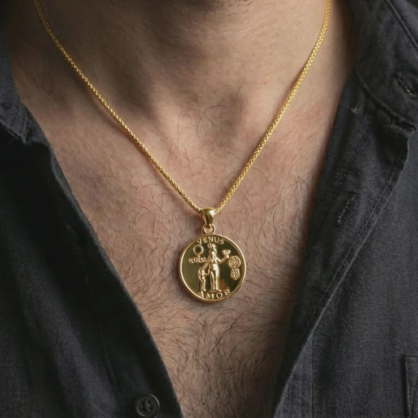 Gold plated Venus Amor pendant necklace worn on the neck, captured on a human model in a premium dark-toned lifestyle frame.
