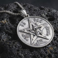 Load image into Gallery viewer, Sterling silver Venus Amor pendant necklace with an oxidized finish resting on textured volcanic rock, captured in a close-up premium studio composition.
