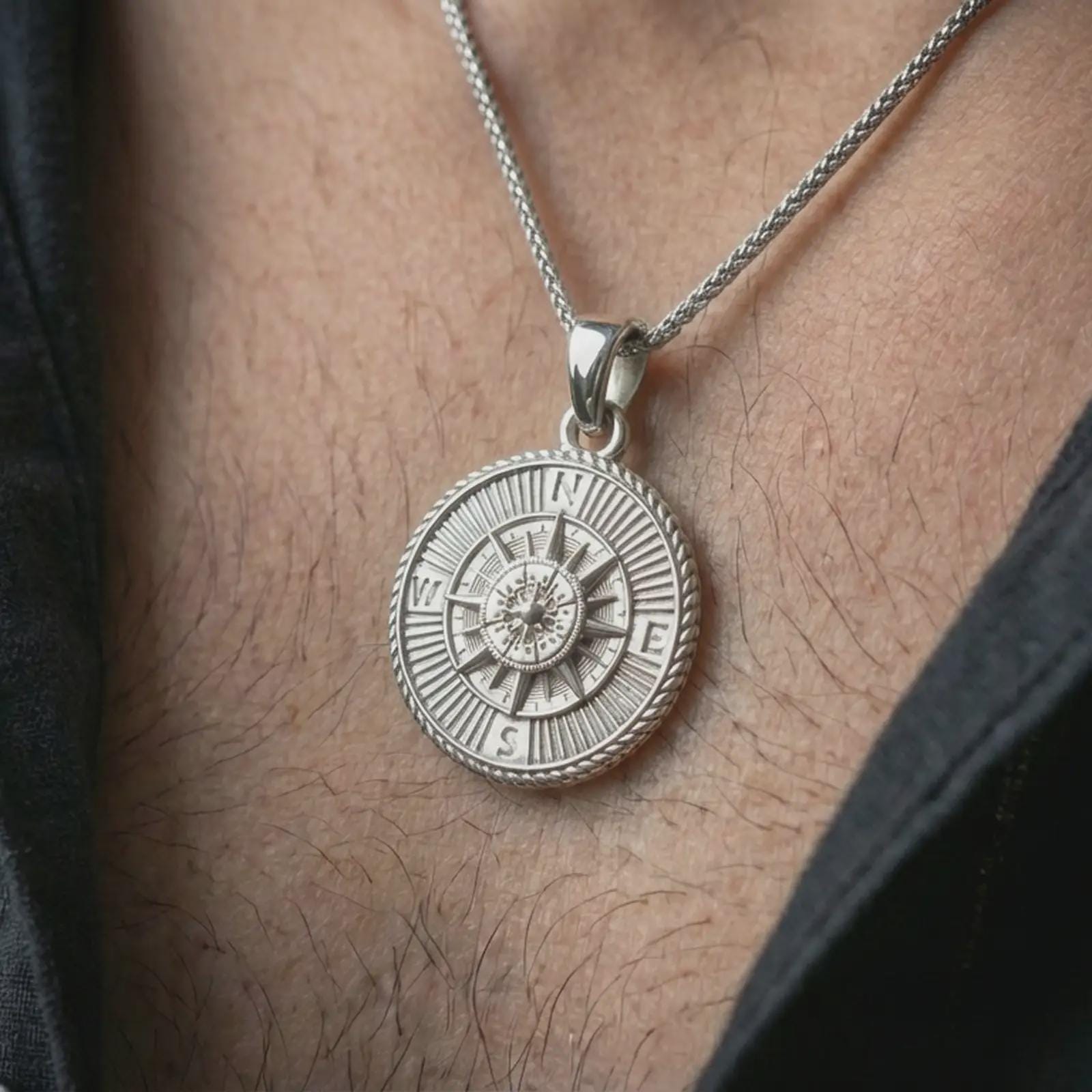 Polished silver steampunk compass pendant necklace worn on the neck, shown against the chest in a clean and elegant everyday wear composition.