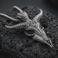Load image into Gallery viewer, Sterling silver Baphomet skull pendant necklace with an oxidized finish resting on textured volcanic rock, captured in a close-up premium studio composition.
