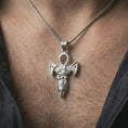 Load image into Gallery viewer, Polished silver Eye of Horus ankh pendant necklace worn on the neck, shown against the chest in a clean and elegant everyday wear composition.
