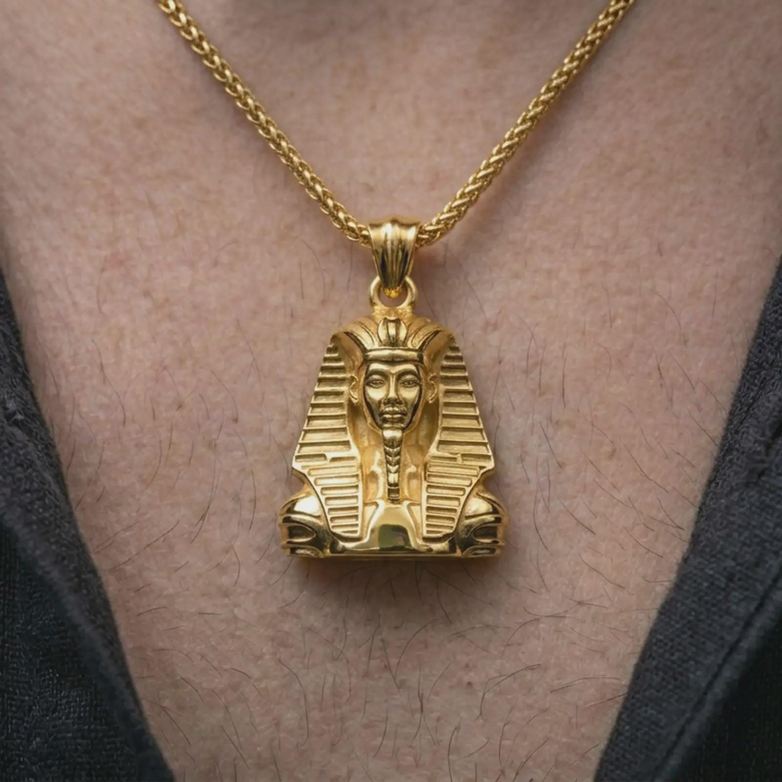 Gold plated Tutankhamun pendant necklace worn on the neck, captured on a human model in a premium dark-toned lifestyle frame.