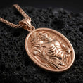 Load image into Gallery viewer, Rose gold plated Saint Sebastian pendant necklace on dark volcanic rock, photographed in a detailed premium studio macro view.
