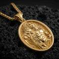Load image into Gallery viewer, Gold plated Saint Sebastian pendant necklace presented on porous volcanic rock, highlighting the oval medallion form and sacred devotional design in a luxurious close-up jewelry image.
