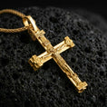 Load image into Gallery viewer, Gold plated Orthodox cross pendant necklace presented on porous volcanic rock, highlighting the sacred cross form in a luxurious close-up jewelry image.
